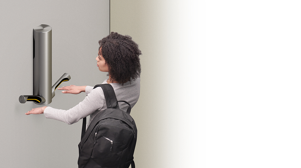 Woman drying hands with Dyson Airblade 9kj