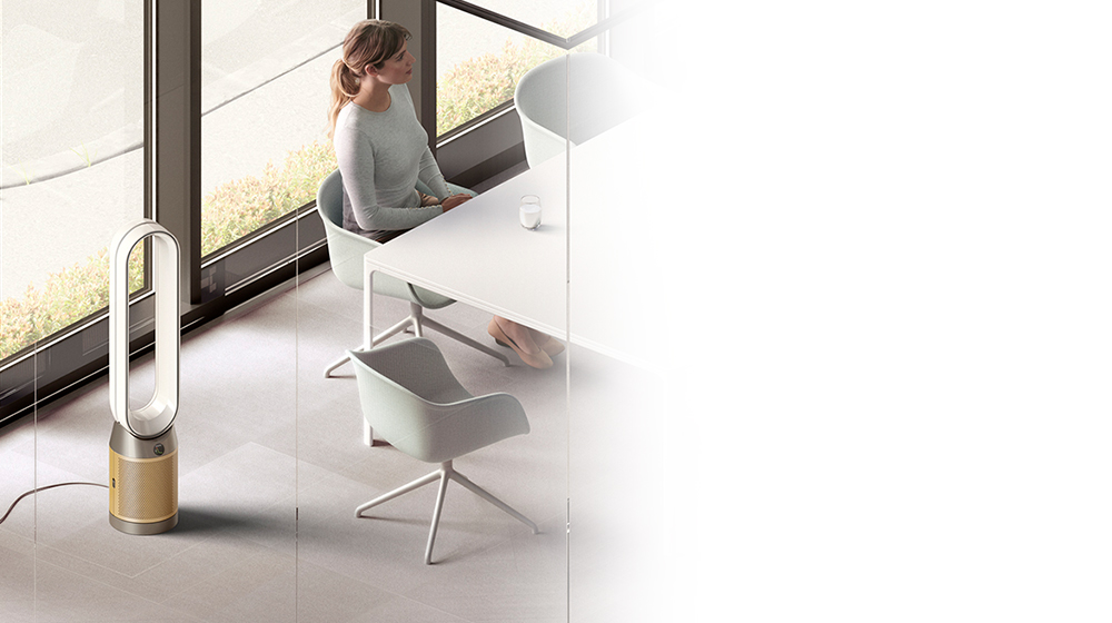 Dyson purifier sitting in corner of office space as meeting takes place