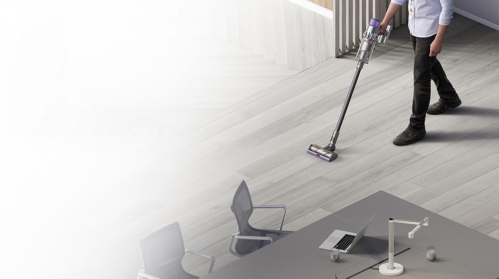 Man cleaning floor with Dyson V15 Detect vacuum 