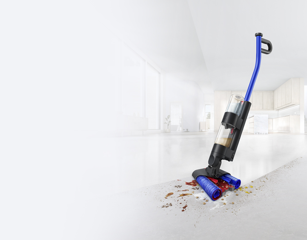 The Dyson WashG1 cleaning debris and spills on a hard floor in a living room