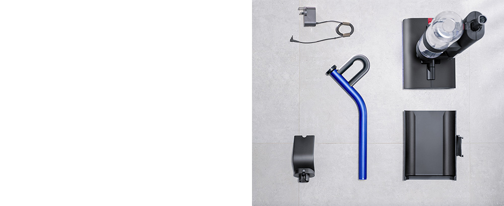 An aerial view of Dyson WashG1 wet cleaner unboxed in pieces, ready to assemble