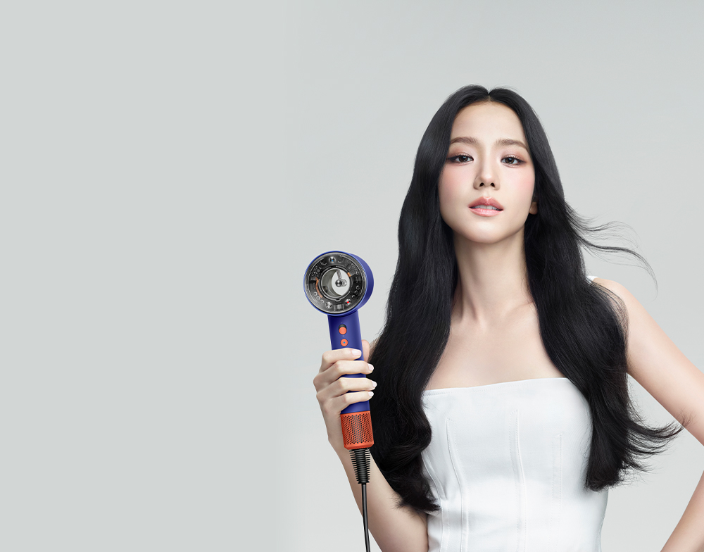 Woman using the Dyson Supersonic Nural hair dryer