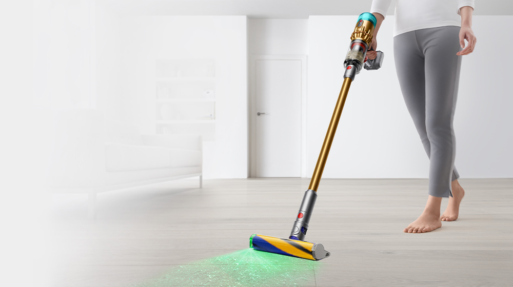 Dyson Micro illuminating and cleaning debris from a hard floor.