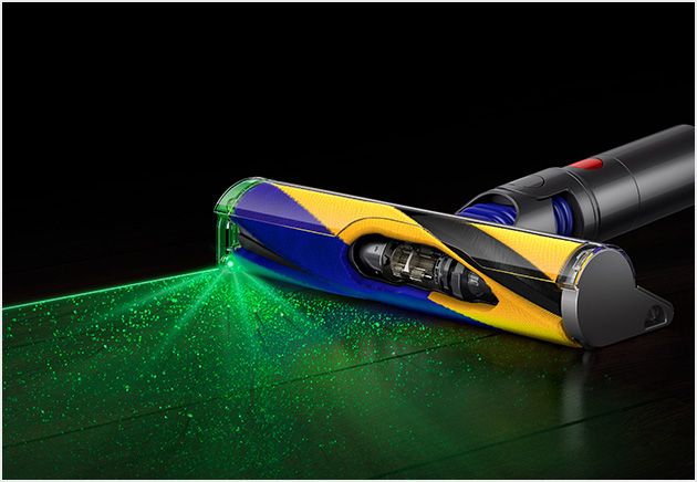 A cutaway of a Fluffy Optic cleaner head illuminating dust on a dark floor.