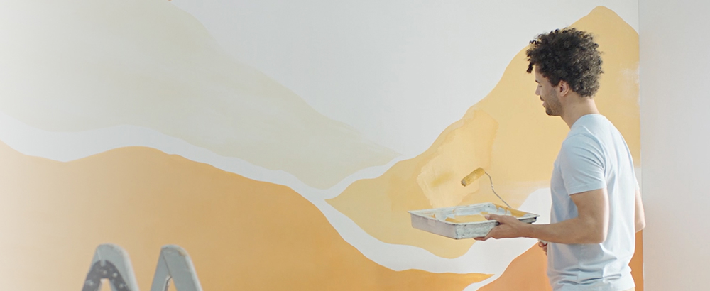 A man painting a wall.