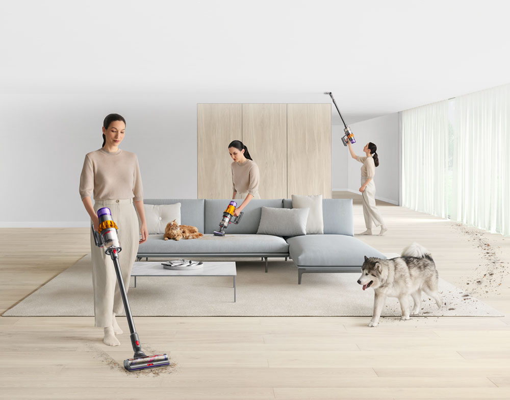 Woman using Dyson to clean all around the home