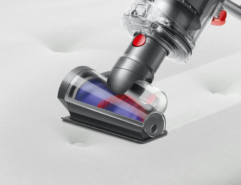 Hair screw tool cleaning a pet mattress.