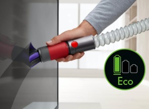 Green Eco mode logo over an image of the extension hose cleaning the side of a kitchen unit.