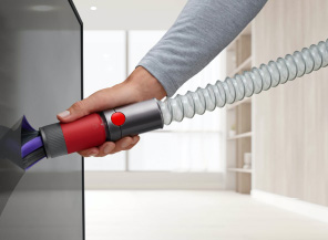 Extension hose being used to reach down low in a kitchen.