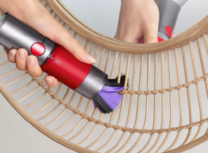 Scratch-free dusting brush cleaning a delicate mirror frame.