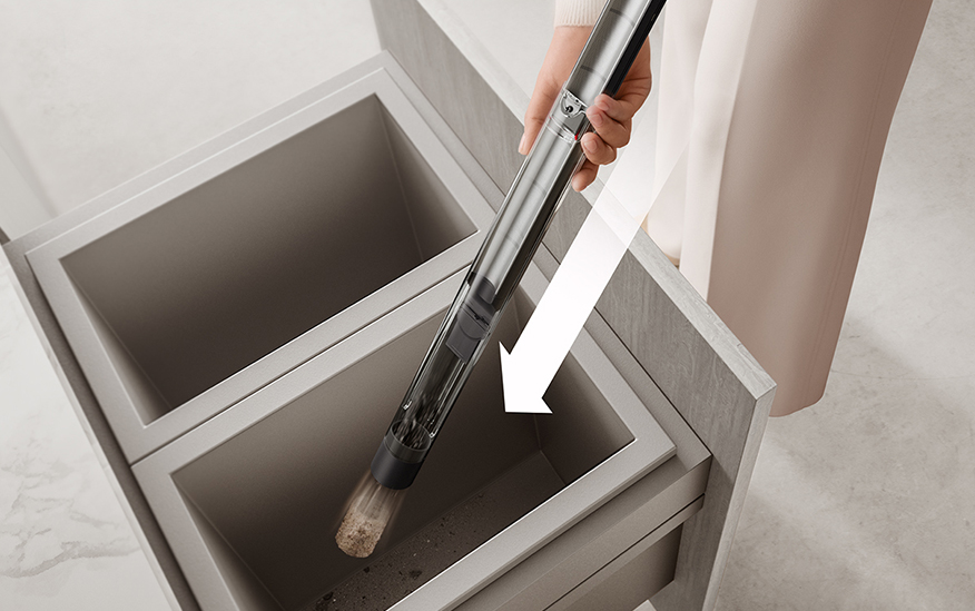 Dyson Pencilvac being emptied into bin
