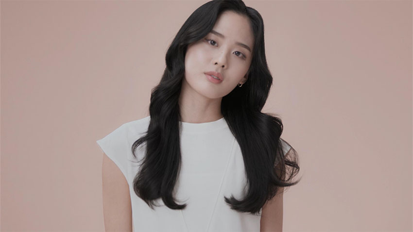 Model wearing smooth c-curl style