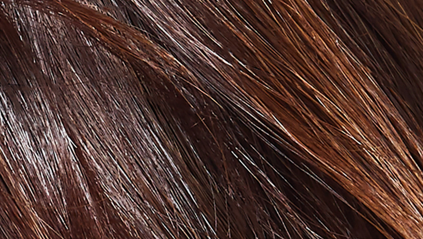 A close-up of shiny, healthy-looking brunette hair.