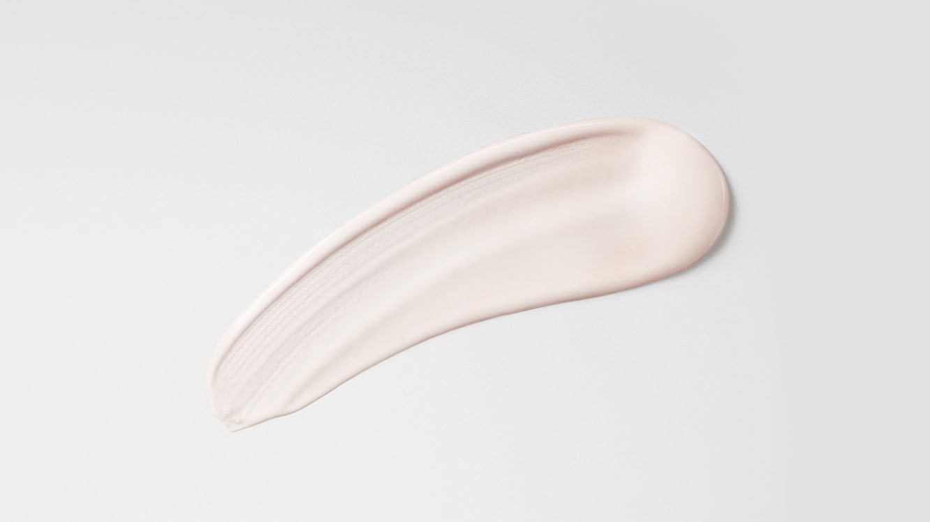 A swipe of post-style serum on white background, showing texture.